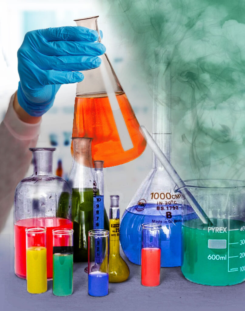 Colorful chemicals in a lab, with one of the beakers emitting green smoke